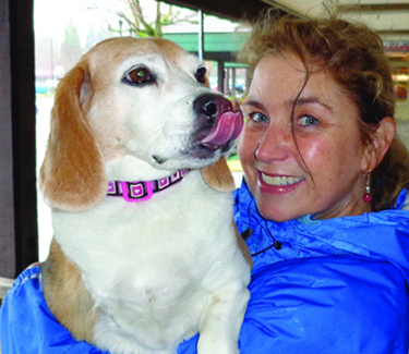 CSUEB Professor Dawna Komorosky holding her beagle, Carly.